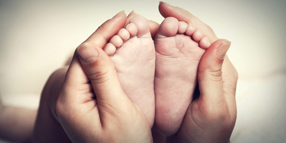 Little,Baby,Feet,In,Mother's,Hands Little,Baby,Feet,In,Mother's,Hands